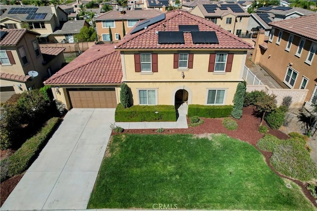 view of front of property with a front lawn, a garage, and solar panels