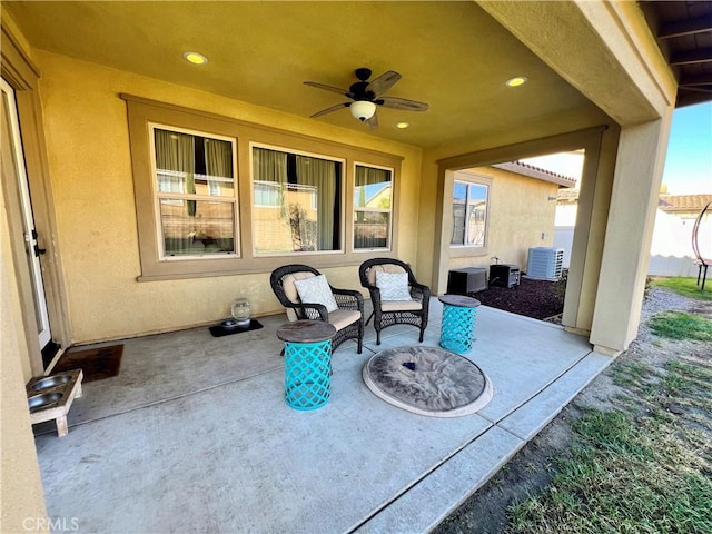 view of patio with ceiling fan and central AC