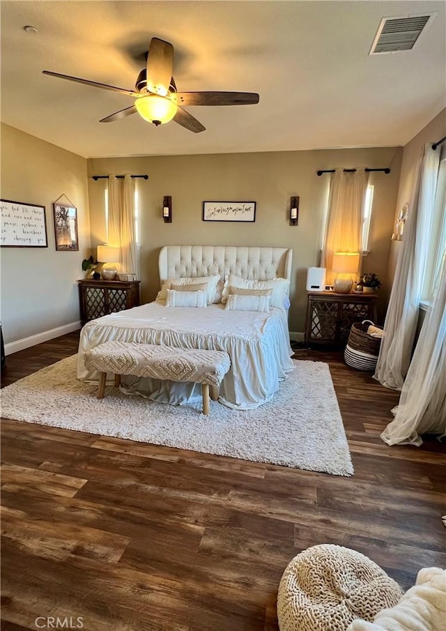 bedroom with ceiling fan and dark hardwood / wood-style flooring