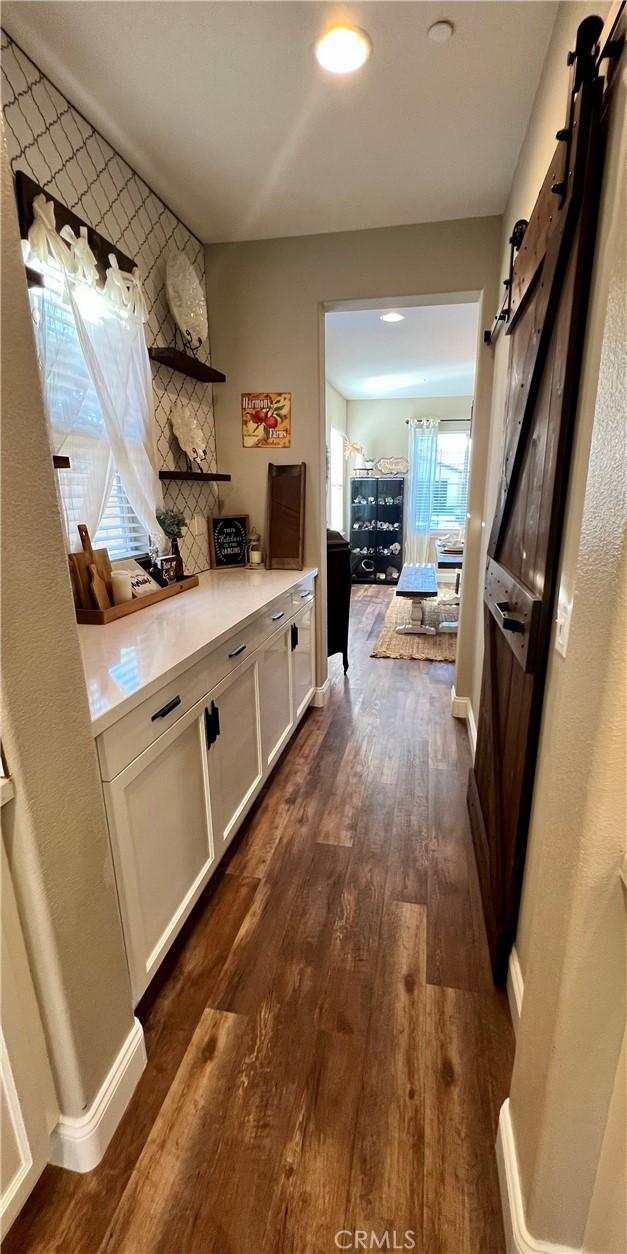 interior space with dark wood-type flooring and a barn door