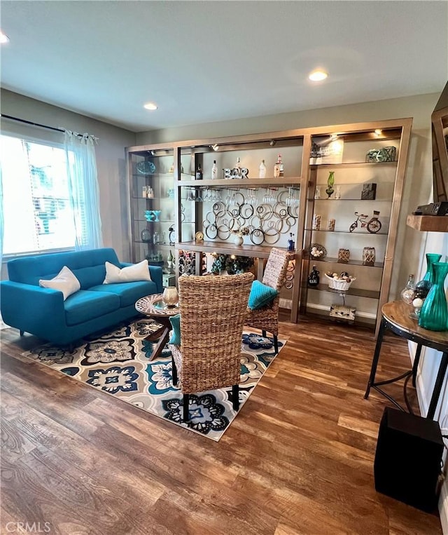 living room featuring wood-type flooring and a fireplace