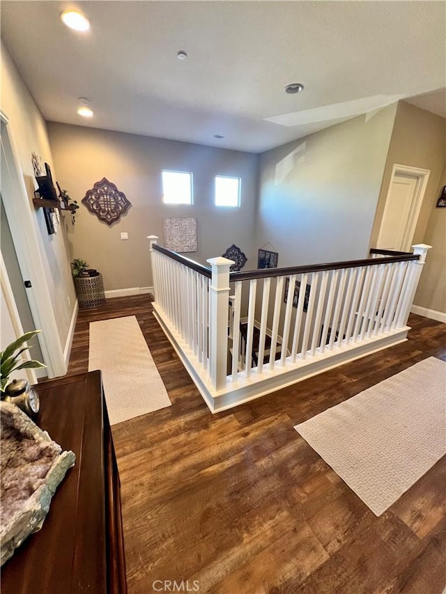 corridor with dark hardwood / wood-style flooring