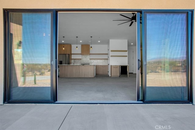 unfurnished living room with ceiling fan