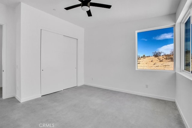 unfurnished bedroom featuring a closet, light colored carpet, and ceiling fan