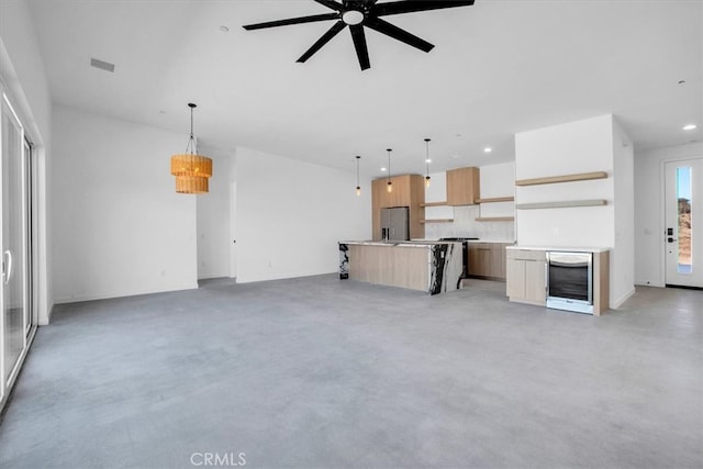 unfurnished living room with ceiling fan