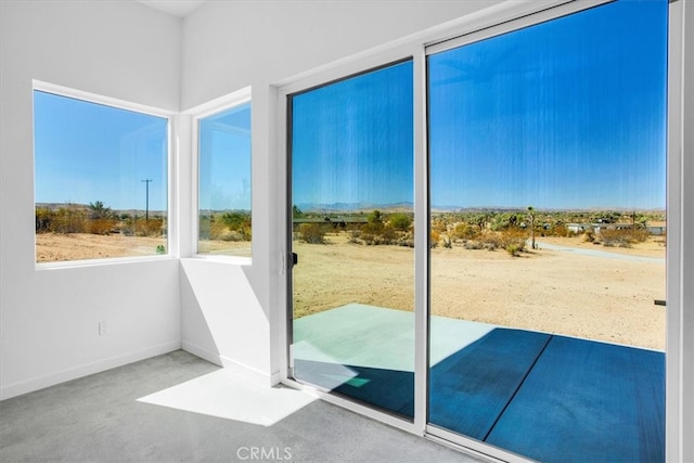 doorway to outside featuring concrete floors