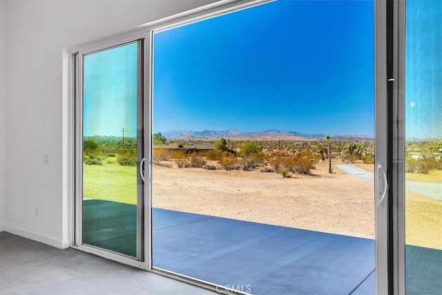 entryway featuring concrete floors and a mountain view