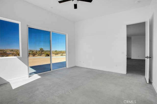 interior space with ceiling fan and light colored carpet