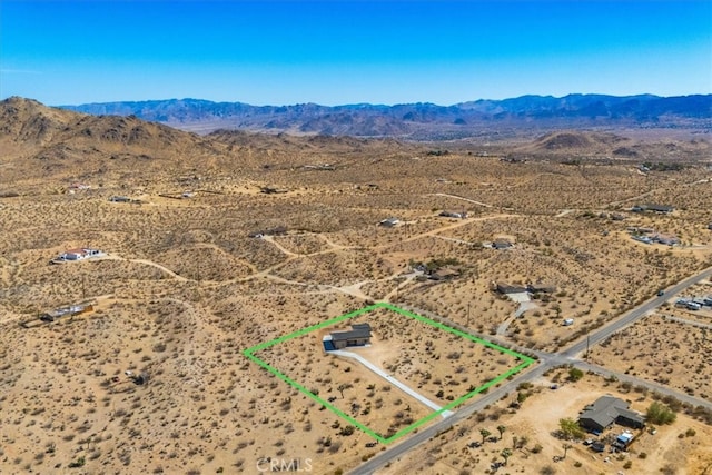 birds eye view of property with a mountain view