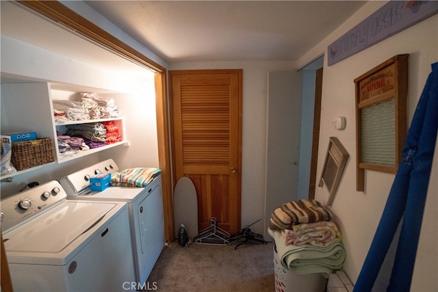 laundry room featuring washing machine and dryer and light colored carpet