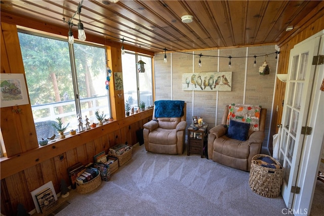 sunroom featuring wooden ceiling and a healthy amount of sunlight