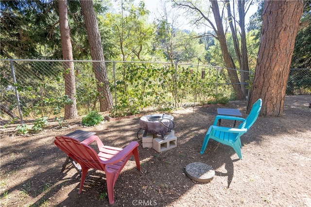 view of yard with an outdoor fire pit