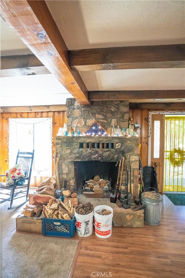 507 Valley Dr, Crestline, CA 92325 - living area with wood walls, a fireplace, beam ceiling, and wood finished floors
