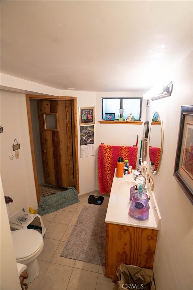 bathroom with vanity, tile patterned flooring, and toilet