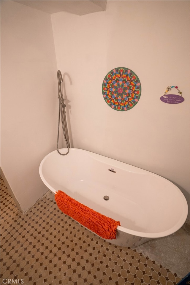 bathroom featuring tile patterned floors and a tub to relax in