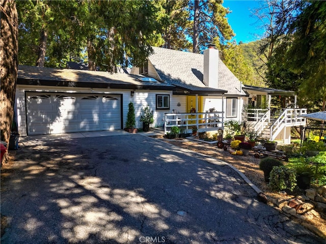 cape cod home featuring a garage