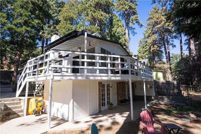 back of house featuring french doors, a patio area, and a deck