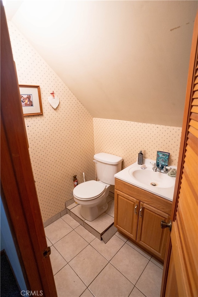 bathroom featuring toilet, tile patterned flooring, and vanity