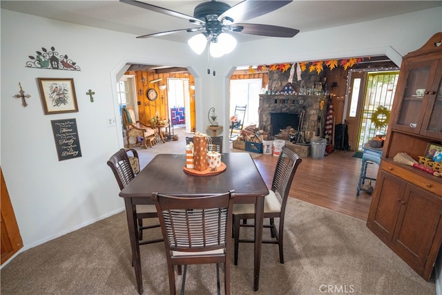 dining room featuring a fireplace, hardwood / wood-style floors, and ceiling fan