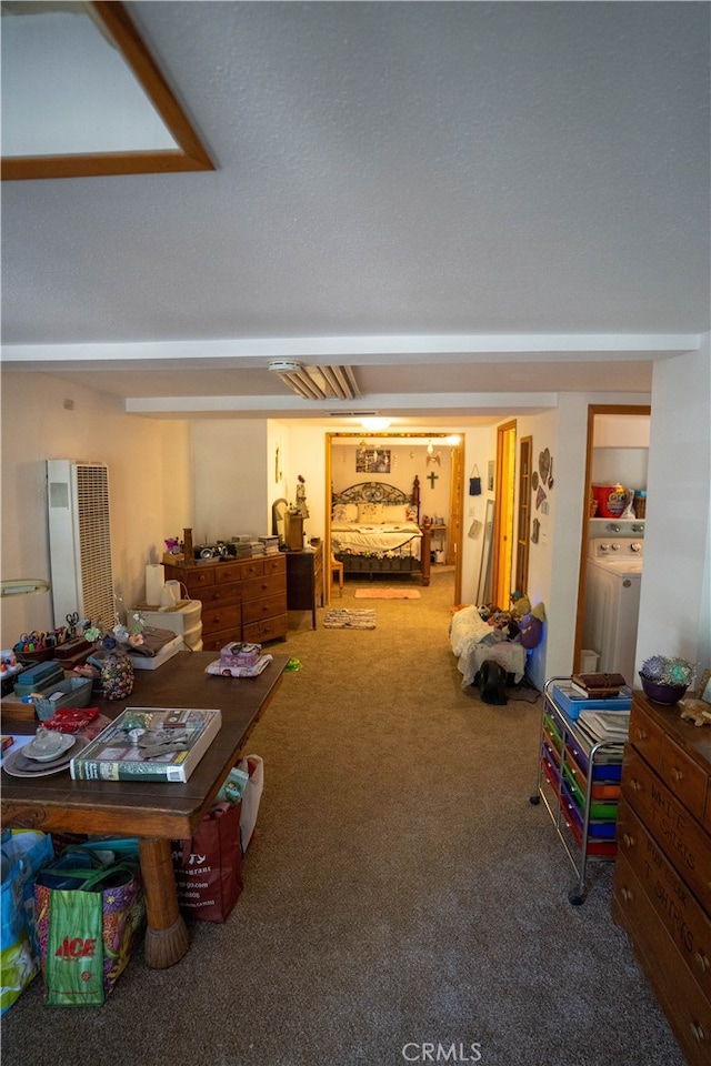 bedroom with washer / clothes dryer and carpet flooring