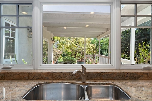 room details featuring stone countertops and sink