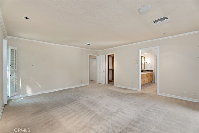 spare room featuring light carpet and ornamental molding