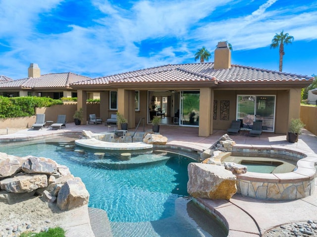 view of pool with an in ground hot tub and a patio