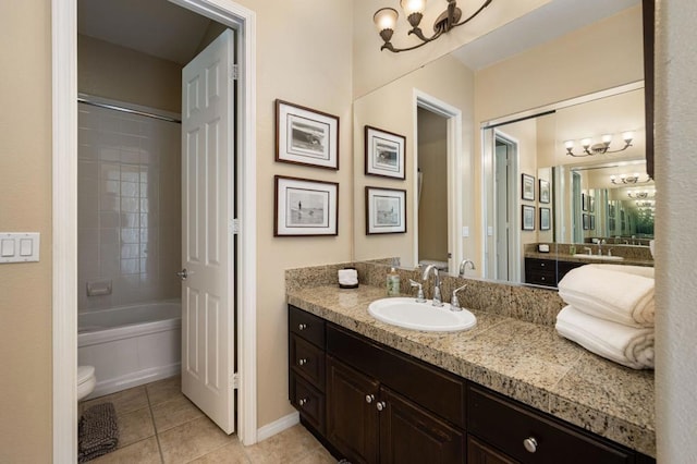 full bathroom featuring toilet, tile patterned flooring, vanity, and tiled shower / bath combo