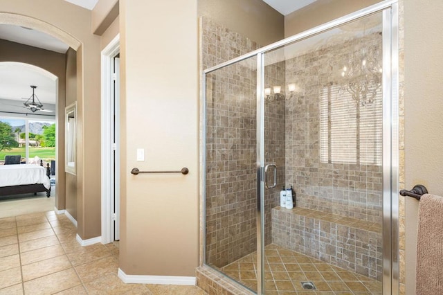 bathroom featuring tile patterned floors and a shower with shower door