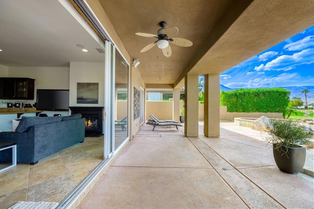 view of patio featuring ceiling fan