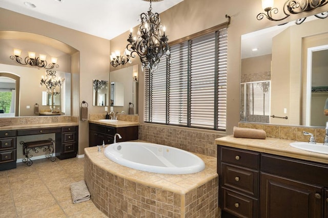 bathroom with plus walk in shower, tile patterned floors, and vanity