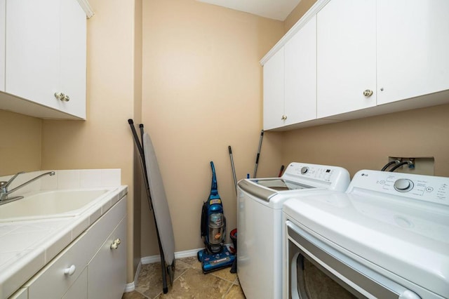 laundry area with cabinets, sink, and washing machine and dryer