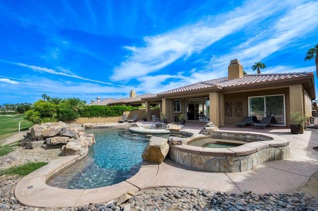 view of swimming pool with an in ground hot tub and a patio area