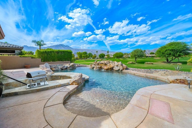 view of pool with a patio, a mountain view, and grilling area