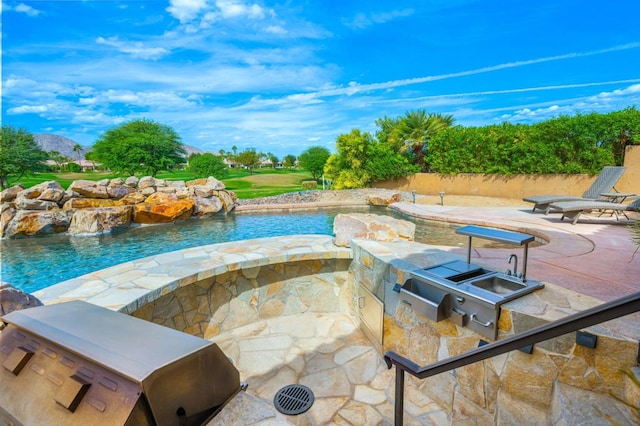 view of swimming pool featuring area for grilling, a patio area, a mountain view, and pool water feature