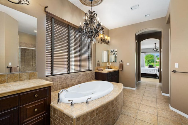 bathroom with tile patterned floors, separate shower and tub, vanity, and a chandelier