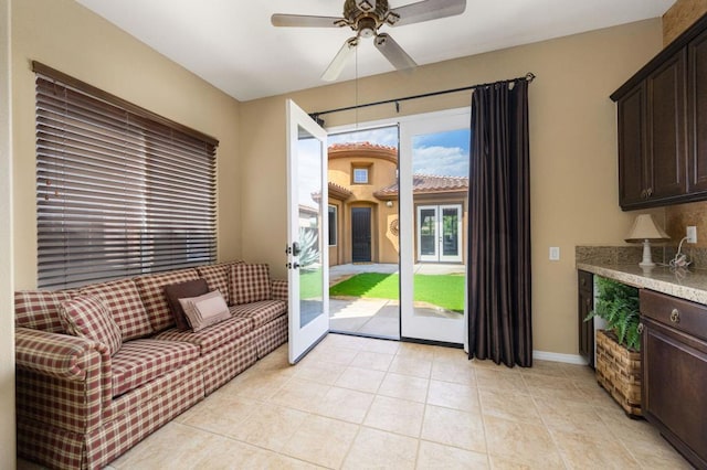 doorway featuring ceiling fan and light tile patterned floors