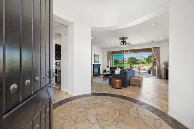 foyer entrance featuring ceiling fan, beverage cooler, and tile patterned floors