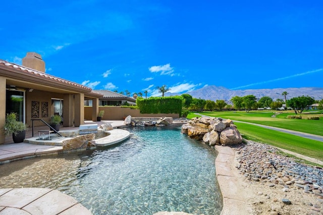 view of pool with a mountain view and a patio area