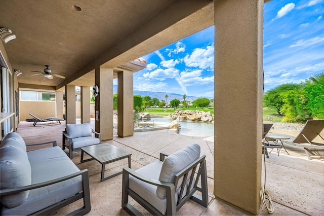 view of patio featuring outdoor lounge area, a water and mountain view, and ceiling fan