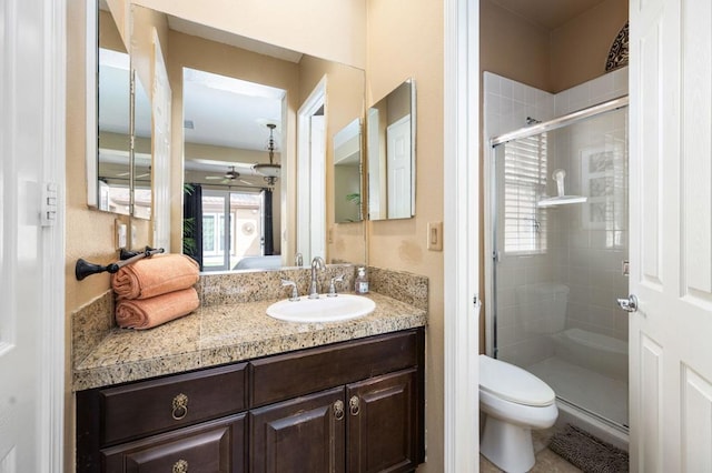 bathroom with an enclosed shower, vanity, and toilet