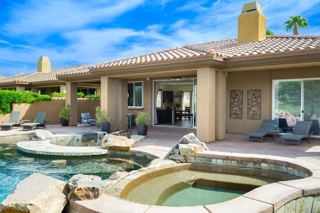 view of pool featuring an in ground hot tub, ceiling fan, and a patio