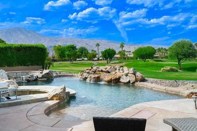 view of swimming pool featuring a lawn and a mountain view