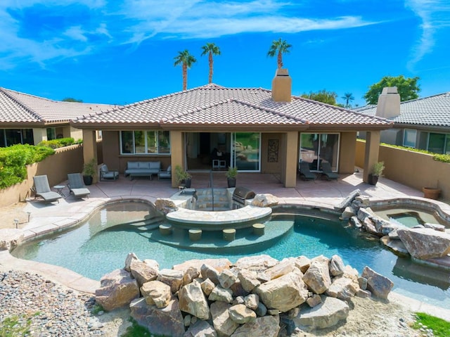 view of pool with an in ground hot tub and a patio area