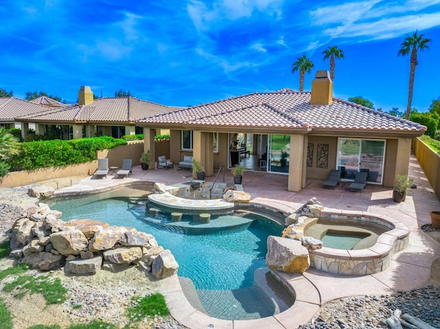 view of swimming pool with an in ground hot tub and a patio area