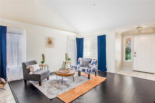 living room with vaulted ceiling, ornamental molding, and light hardwood / wood-style floors