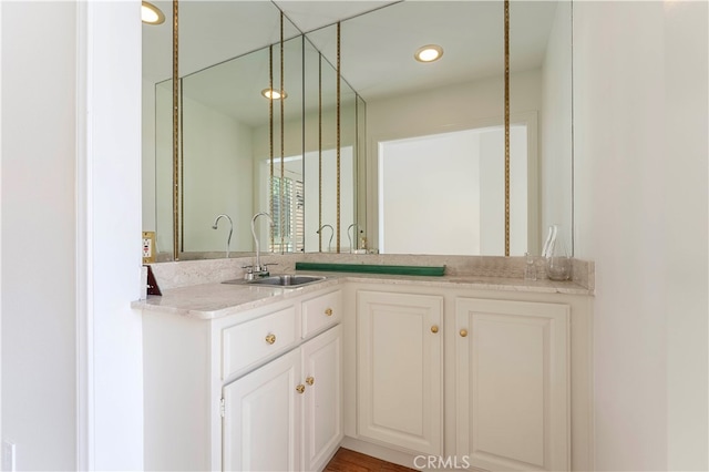 bathroom with hardwood / wood-style floors and vanity