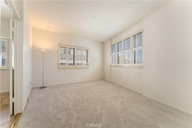 spare room with carpet floors and baseboards