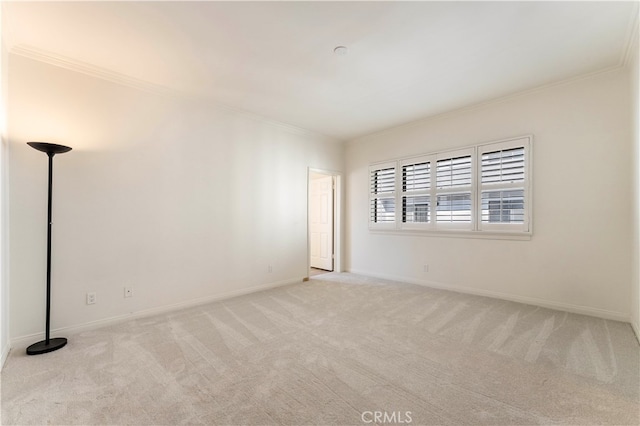 carpeted spare room featuring crown molding