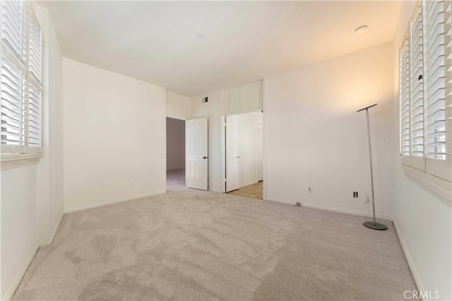 unfurnished room with light carpet